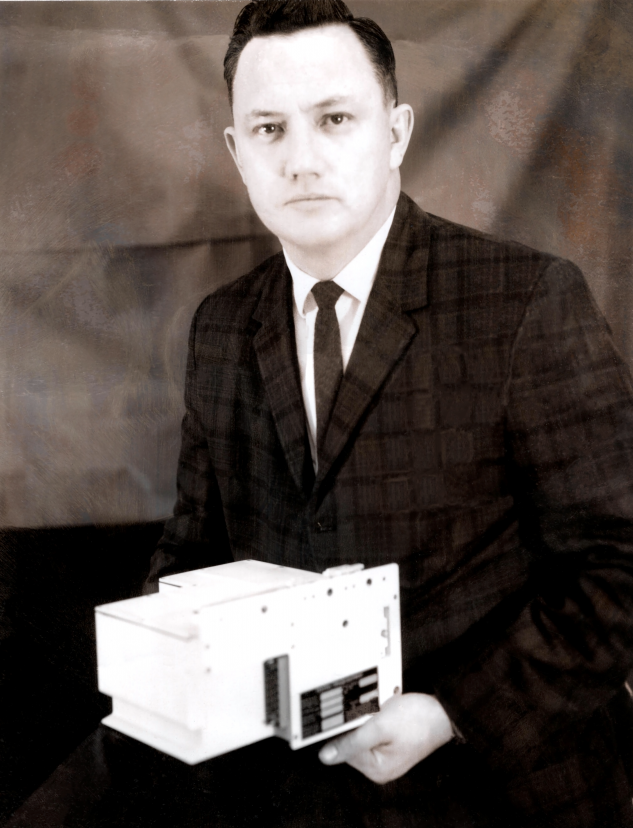 Pictured is our company founder, Victor J. Habisohn with the first prototype of the Central Timing Equipment used on all Apollo and Lunar Excursion Module (L.E.M.) missions.